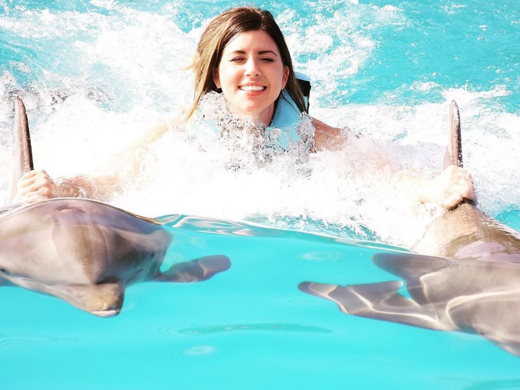 Christina Frank swimming with dolphins