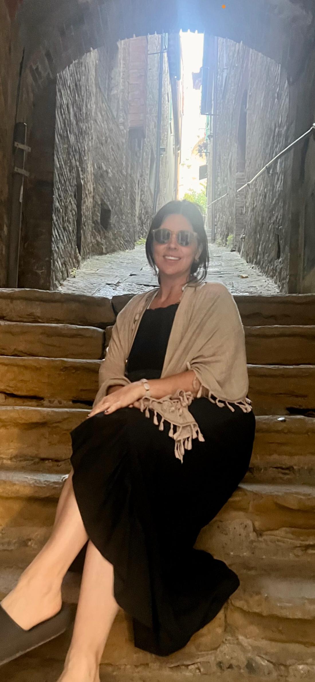 Christina Frank on a stone stairway in Italy